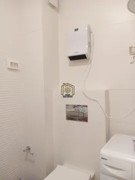 View of the bathroom with sanitary ware and an electric wall heater. - image 7