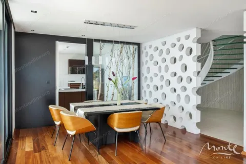 Dining area with wooden flooring, a dining table and chairs. - image 5