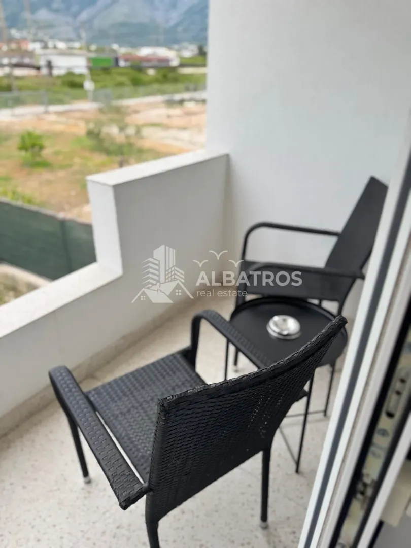 Small furnished balcony with chairs and a small table.