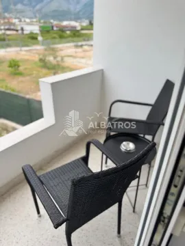 Small furnished balcony with chairs and a small table. - image 6