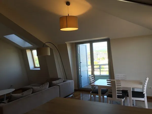 Spacious living room with seating set and dining area.