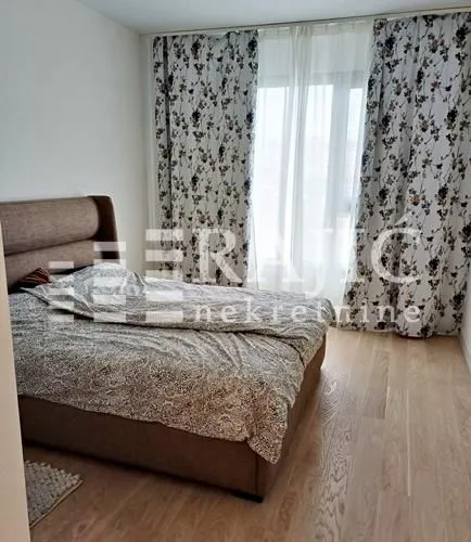 Bedroom with a double bed and a window with curtains.