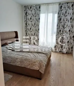 Bedroom with a double bed and a window with curtains. - image 4