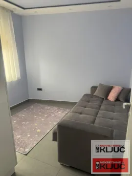 Manja spavaća soba sa krevetom i tepihom. - image 6