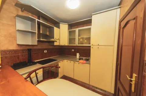 Small kitchen with light cabinetry, a sink, and a built-in cooktop. - image 7