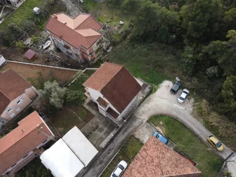 Aerial view of houses with red roofs and yards. - image 4