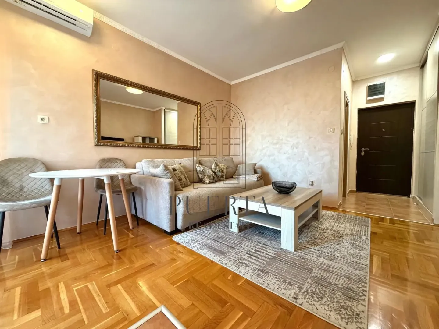 Living room with a sofa, coffee table and dining table.