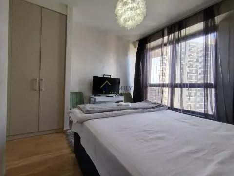 Furnished bedroom with a large double bed, wardrobe, and a window. - image 12