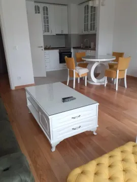 Living room with a dining area and kitchen in the background. - image 5