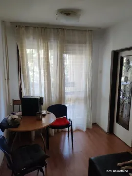 Small room with a dining table, chairs, and a window with curtains. - image 13