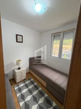 Smaller bedroom with a pull-out bed and a nightstand. - image 6