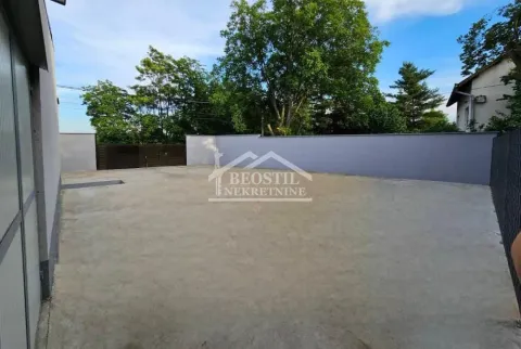 Enclosed yard with a concrete surface and a gate. - image 14