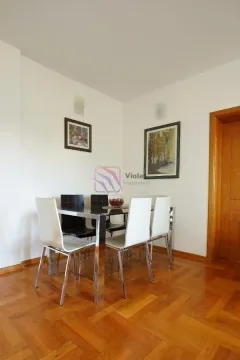 Dining area with a table and chairs and parquet flooring. - image 4