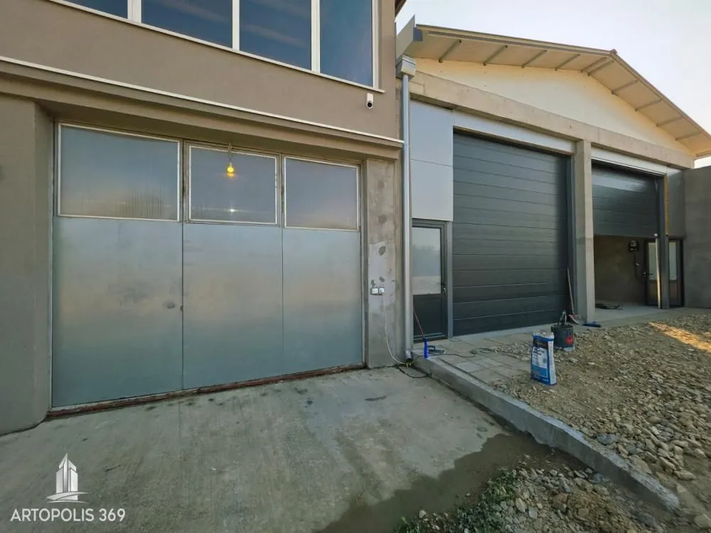 Exterior of the building with entrance doors and garage space.