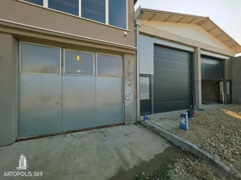 Exterior of the building with entrance doors and garage space. - image 13