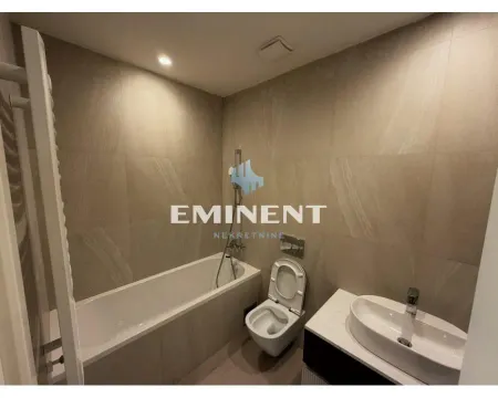 Modern bathroom equipped with a bathtub, washbasin, and toilet. - image 7
