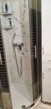 Bathroom with a shower cabin and a white bathroom cabinet. - image 15