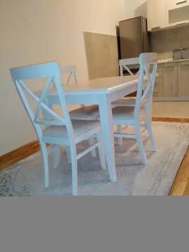 Dining table with chairs in the kitchen area. - image 8