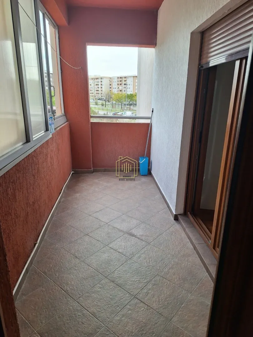 Covered balcony with tiled flooring and a view of the neighborhood.