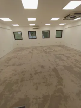 Spacious empty room in shell condition with windows and lighting. - image 4