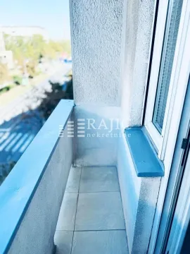 View of a small tiled balcony with a railing. - image 11