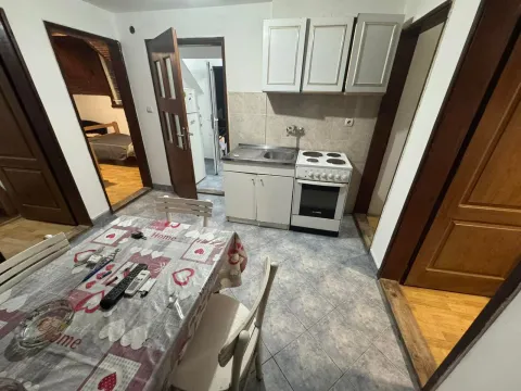 Smaller kitchen with a dining table and cabinets. - image 7
