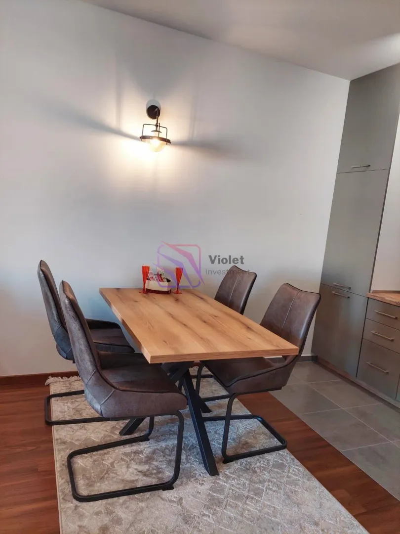 Dining area with a wooden table and modern chairs.