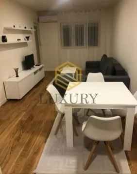 Living room with a dining area and seating set. - image 2