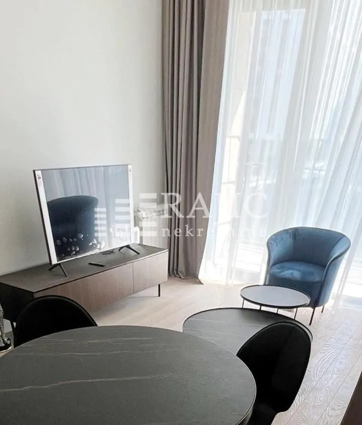 Modern living room with seating area and dining table.