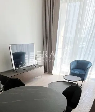 Modern living room with seating area and dining table. - image 7