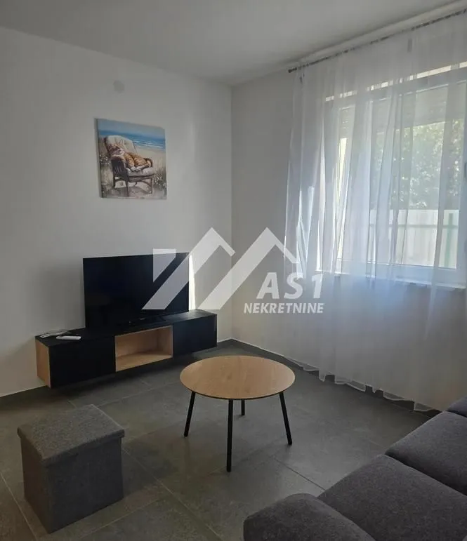 Living room with a sofa, TV, and coffee table.