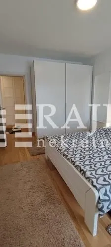Bedroom with a double bed, large wardrobe, and a doorway leading to the hallway.