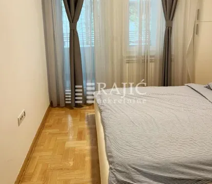 Bedroom with a double bed and a window with curtains. - image 8