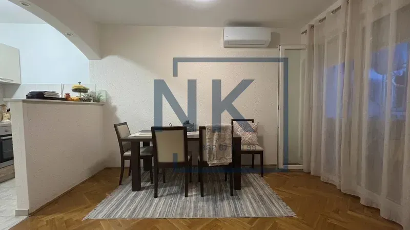 Dining area with a table and chairs, connected to the kitchen.
