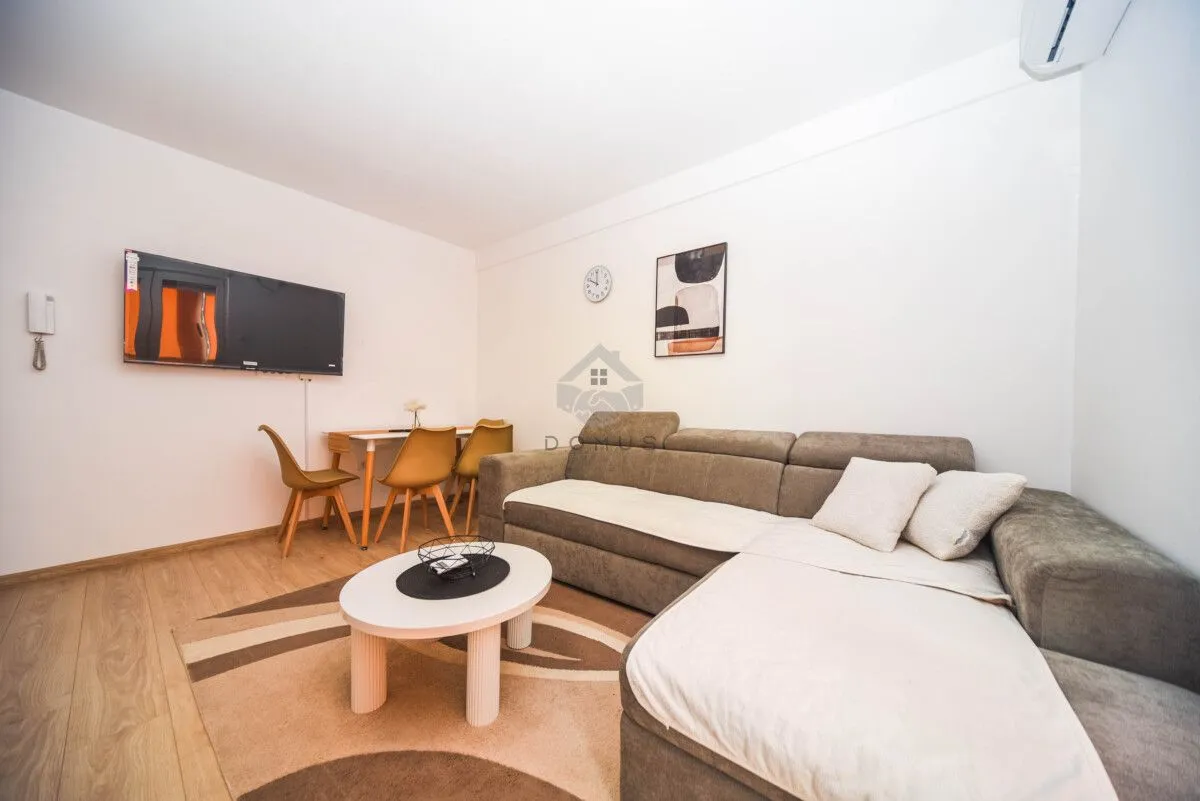 Living room with a sectional sofa, coffee table, and dining area.