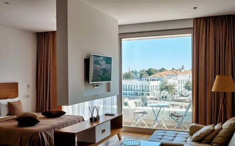 Bedroom with a double bed and a city view. - image 6