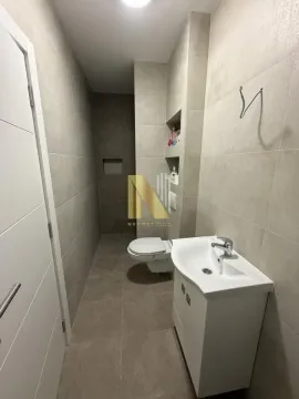 Modern bathroom with a sink, toilet, and tiled shower area. - image 6