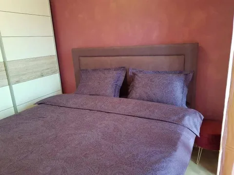 Furnished bedroom with a double bed and wardrobe. - image 10