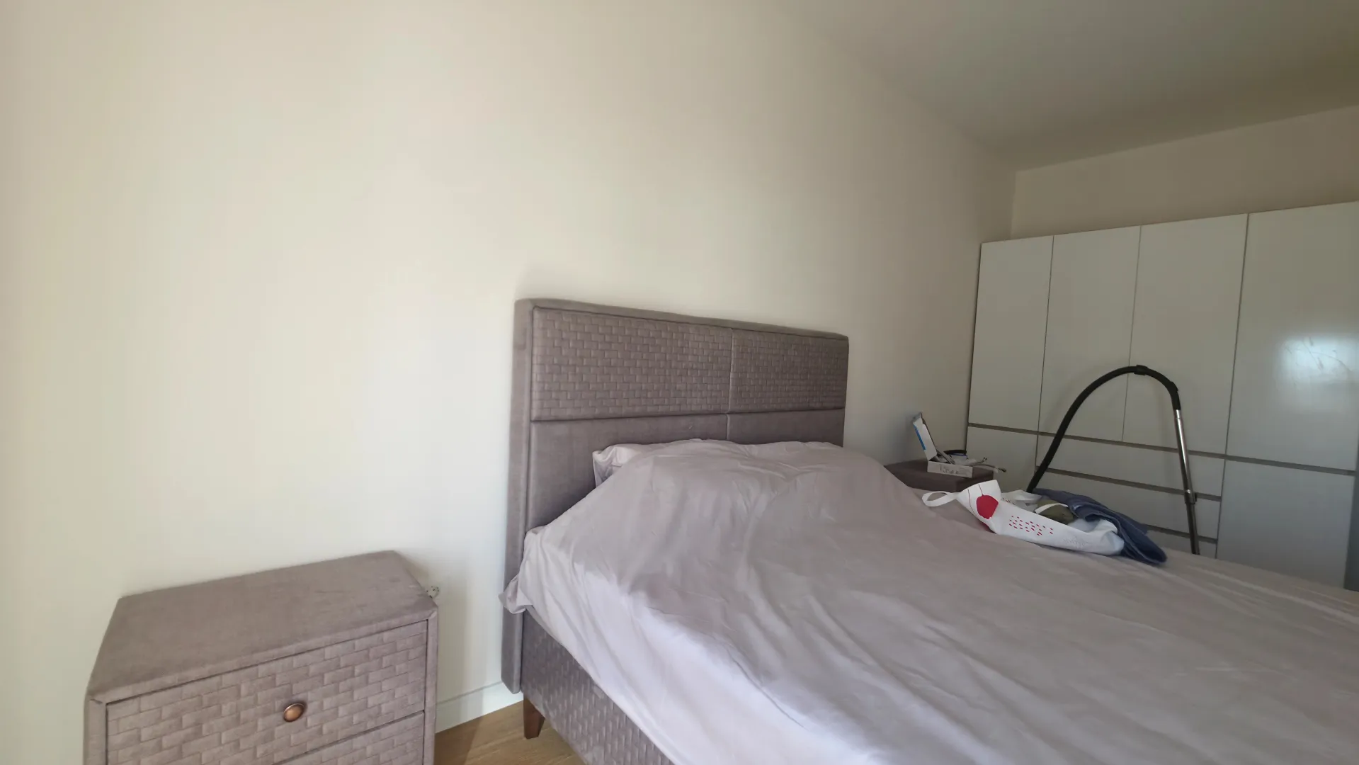 Bedroom with a double bed, wardrobe, and nightstand.