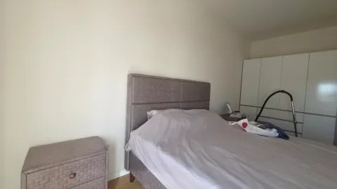 Bedroom with a double bed, wardrobe, and nightstand. - image 4