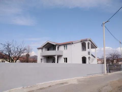 Bright two-story house with spacious terraces behind a concrete fence. - image 18