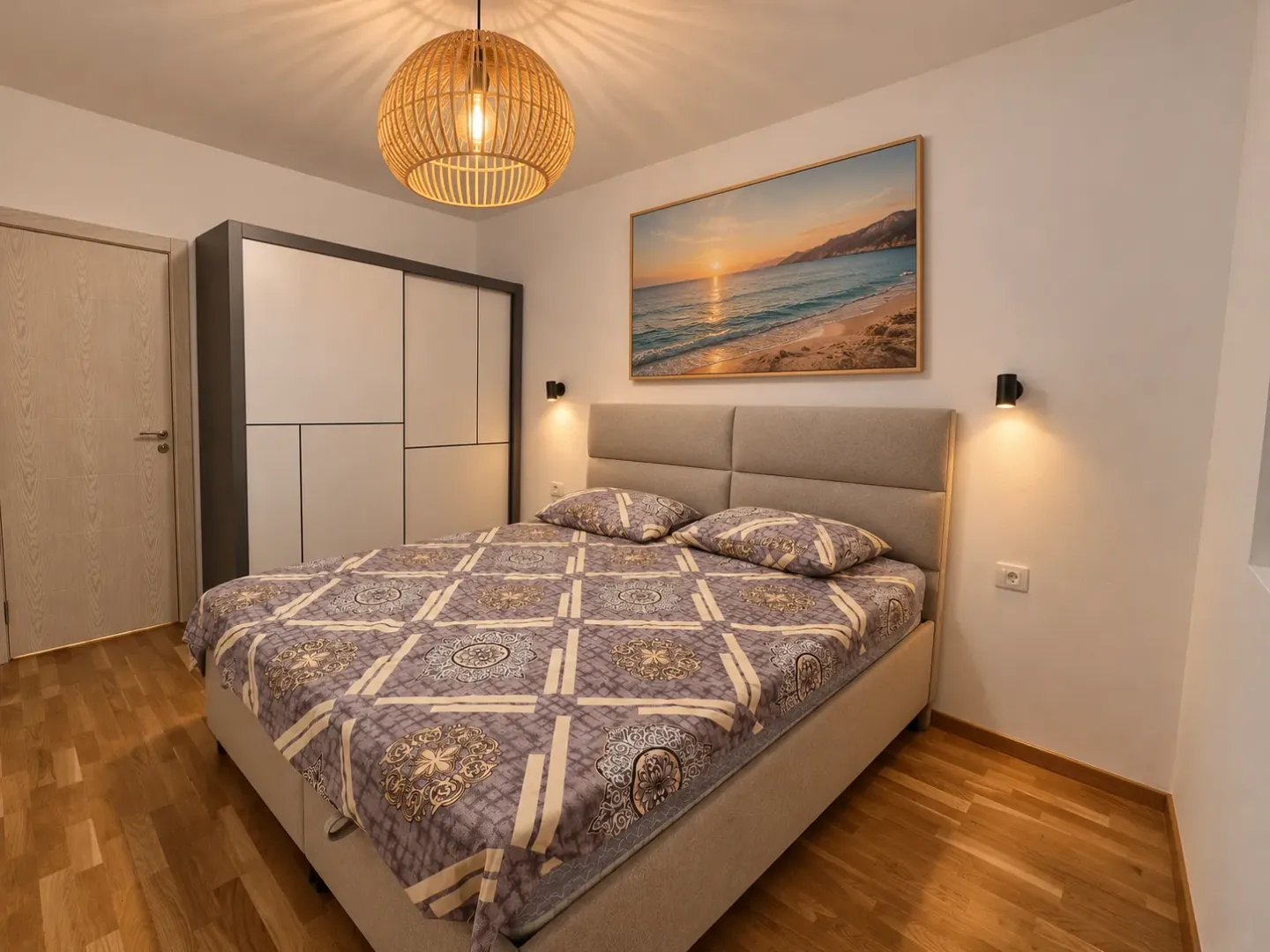 Modern bedroom with a double bed, wardrobe, and lighting.