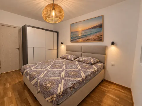Modern bedroom with a double bed, wardrobe, and lighting. - image 4