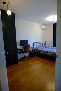 Bedroom with a double bed, a desk, and a dark wardrobe. - image 5