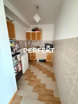 Small kitchen with wooden elements and tiled flooring. - image 3
