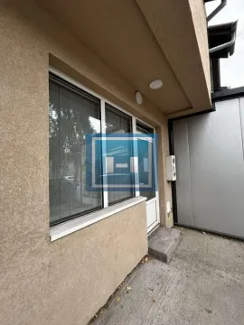 View of the exterior entrance of the building with a window and door. - image 5