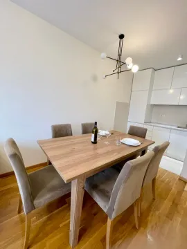 Dining table with chairs as part of the living area with a kitchen. - image 3