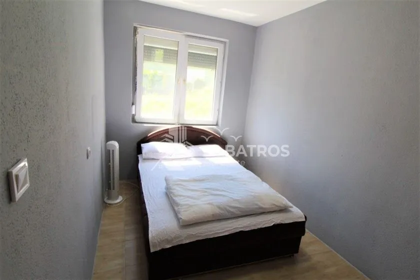 Smaller bedroom with a double bed and a window.