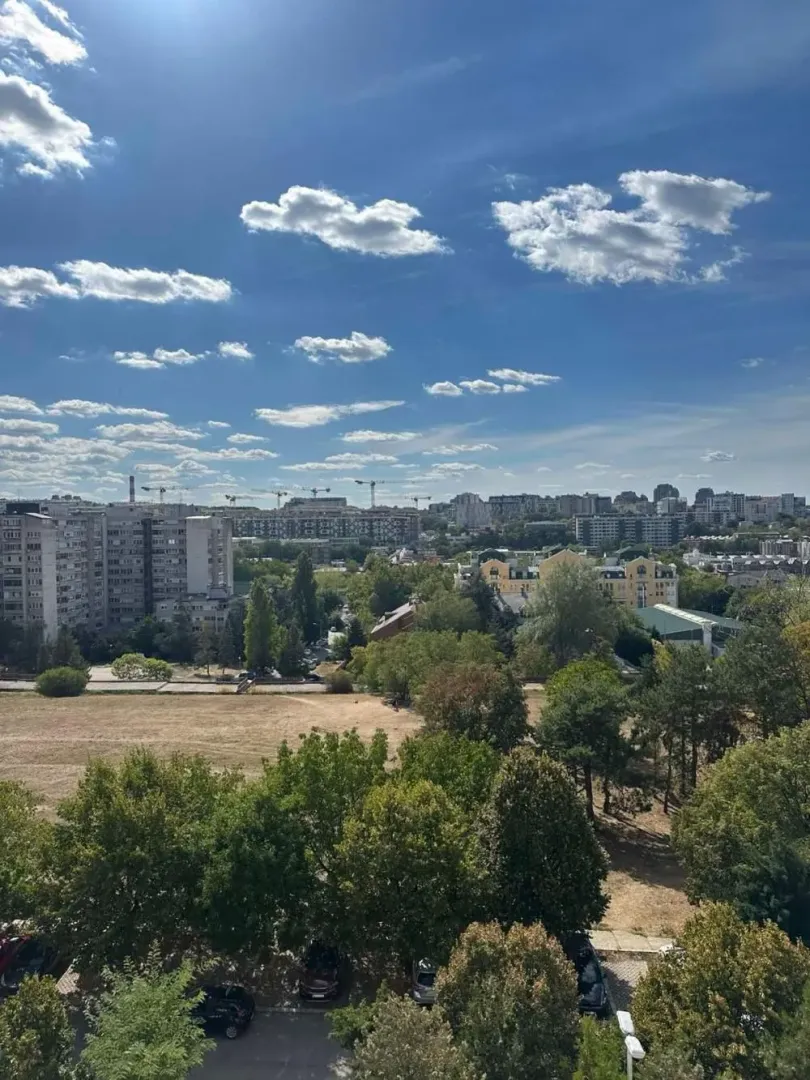 View from the window overlooking the urban settlement and greenery.