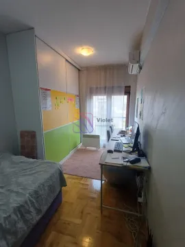 Smaller bedroom with a bed, large wardrobe, and a desk. - image 6